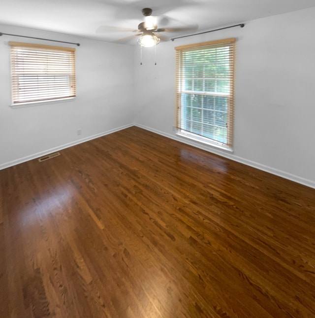 unfurnished room featuring ceiling fan and dark hardwood / wood-style floors