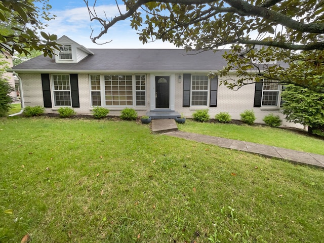 single story home featuring a front lawn