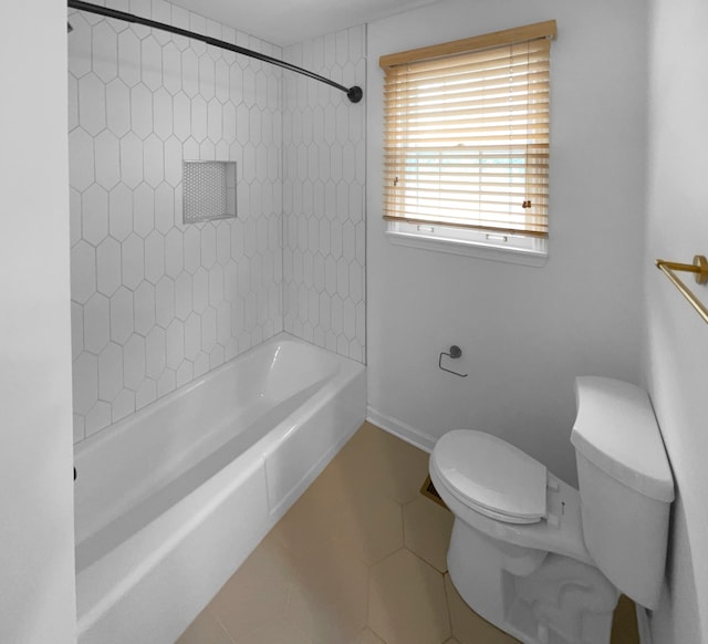 bathroom with toilet, tile flooring, and tiled shower / bath combo