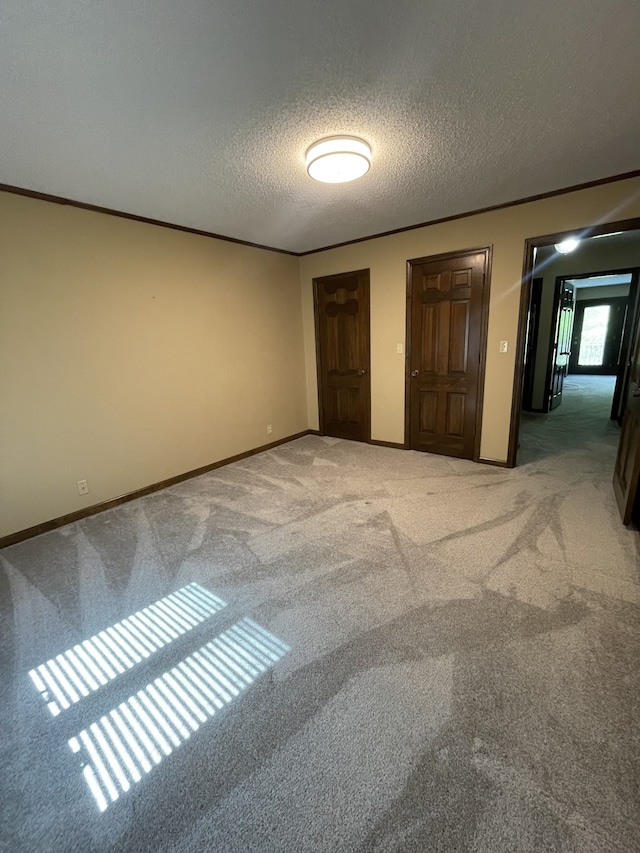 unfurnished bedroom with carpet flooring and a textured ceiling