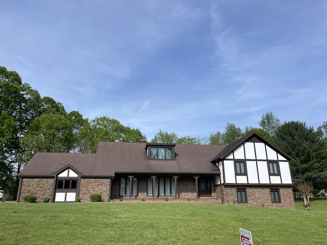 tudor home featuring a front yard