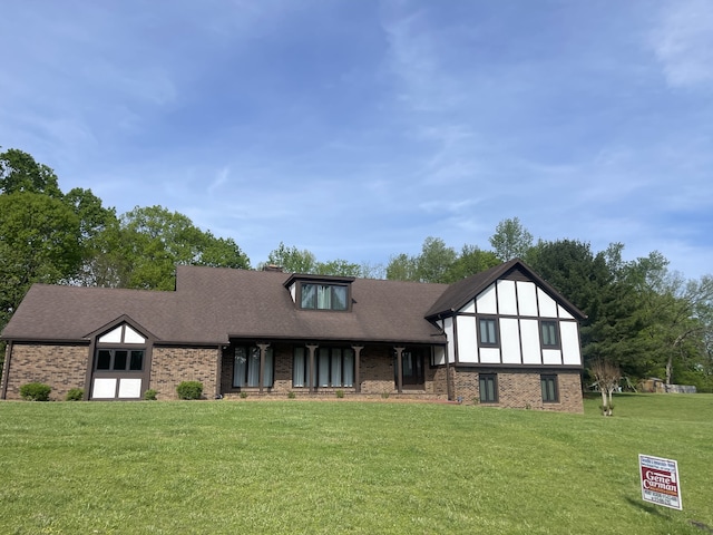 english style home with a front lawn