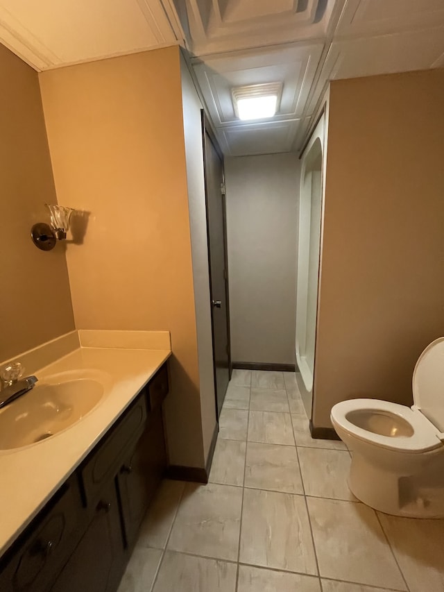 bathroom with tile patterned flooring, vanity, toilet, and a shower