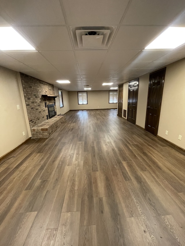 basement featuring a fireplace and wood-type flooring