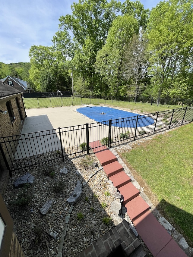 view of pool featuring a lawn and a patio area