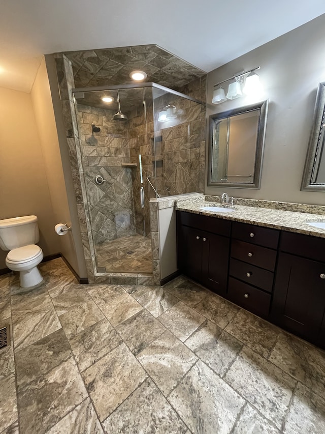 bathroom with vanity, an enclosed shower, and toilet