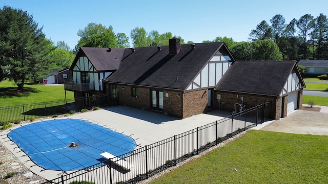 view of swimming pool featuring a lawn and a patio