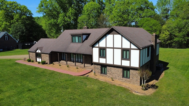 rear view of house with a yard