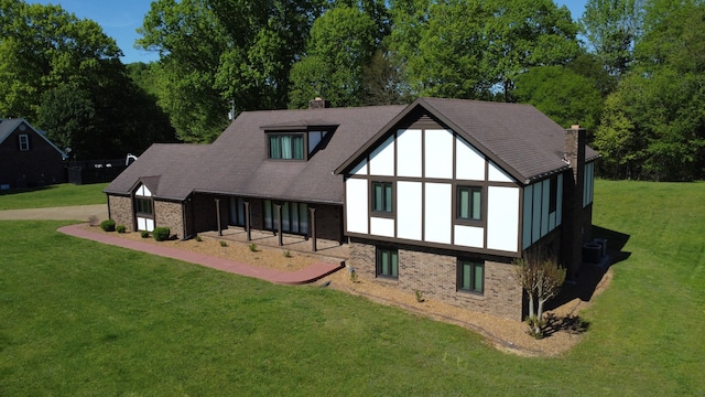 back of house with a lawn