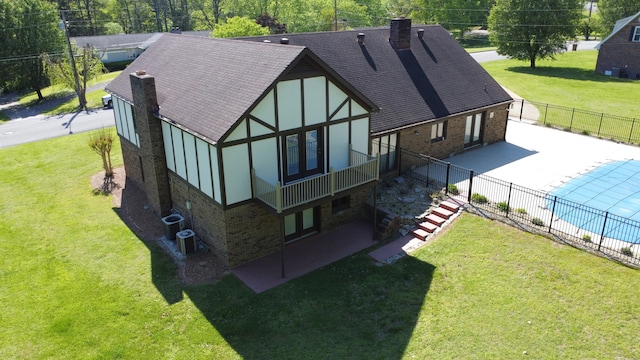 back of house with a patio, central AC, and a lawn