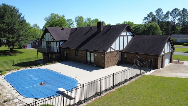 view of swimming pool featuring a patio area and a yard