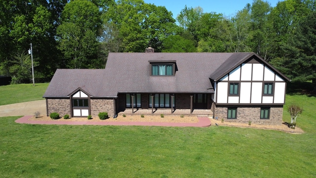 back of house with a lawn