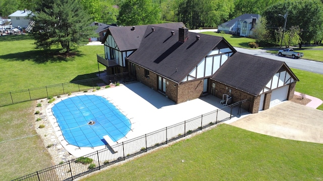 view of pool with a yard, a diving board, and a patio area