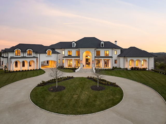 french provincial home featuring a lawn