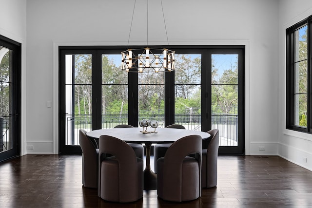 dining area with a chandelier and dark hardwood / wood-style floors