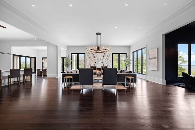 dining room with ornamental molding, dark hardwood / wood-style flooring, and a notable chandelier