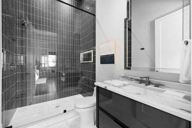 bathroom with oversized vanity, an enclosed shower, toilet, and tile flooring