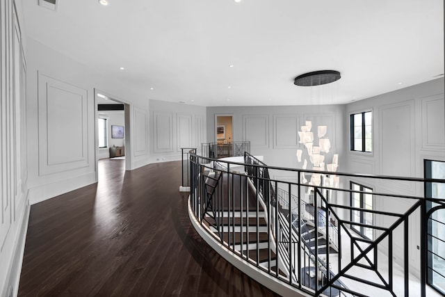 hallway with dark hardwood / wood-style floors