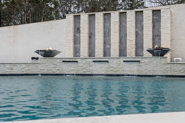 view of swimming pool featuring pool water feature