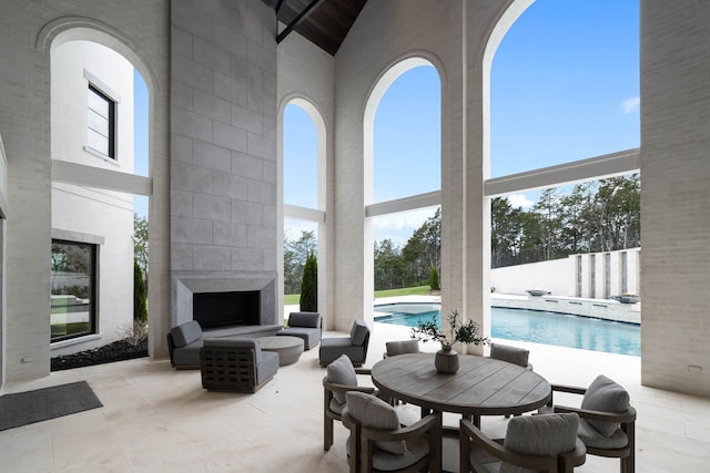 interior space featuring a towering ceiling and a large fireplace