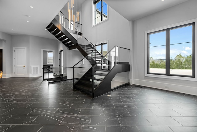 stairway featuring dark tile flooring