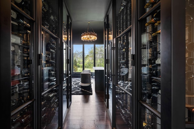 wine cellar with dark hardwood / wood-style flooring and a notable chandelier