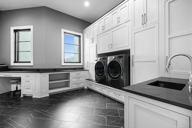 laundry room with cabinets, a wealth of natural light, sink, and washer and dryer