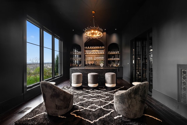 wine cellar featuring a chandelier and dark wood-type flooring