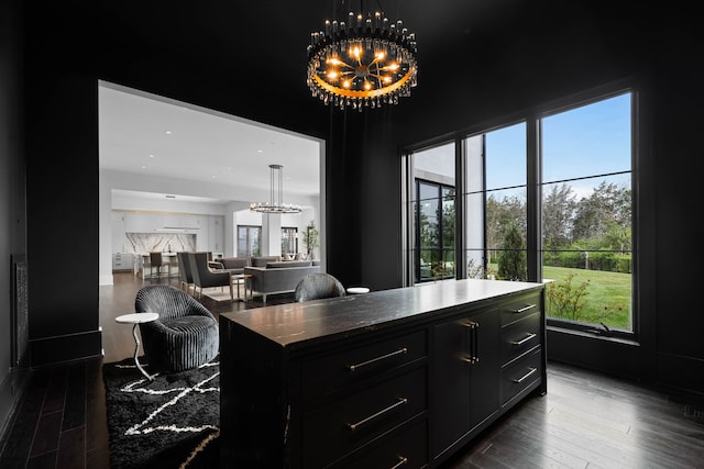 office area featuring a healthy amount of sunlight, dark hardwood / wood-style flooring, and a chandelier