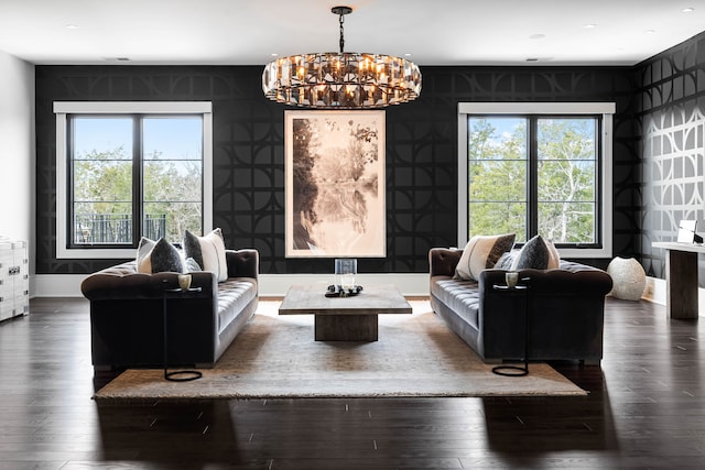 living room with dark hardwood / wood-style flooring and an inviting chandelier