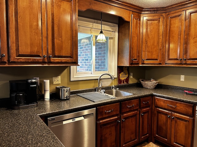 kitchen with dark countertops, decorative light fixtures, dishwasher, and a sink