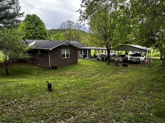 exterior space featuring a carport, brick siding, and a yard