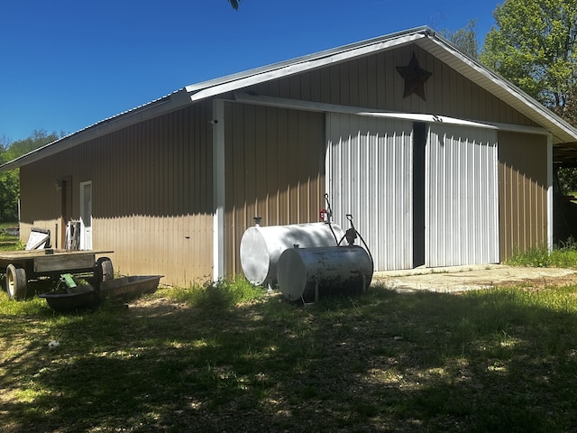 view of side of property with an outbuilding, heating fuel, and a pole building