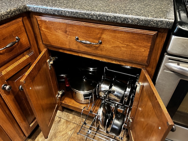 room details with stove and brown cabinets