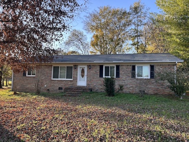 ranch-style home featuring entry steps, brick siding, crawl space, and a front lawn