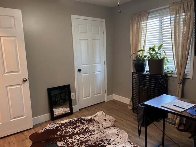 interior space with baseboards and wood finished floors