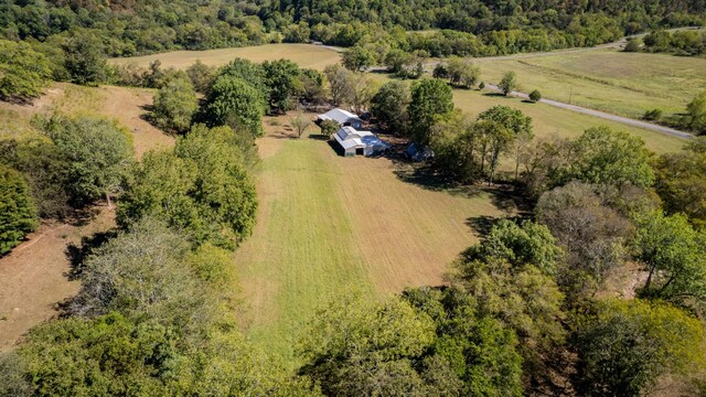 drone / aerial view with a wooded view and a rural view