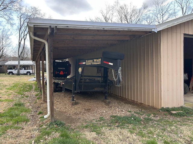 view of car parking featuring an attached carport and a pole building