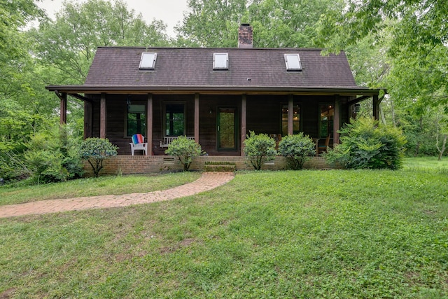 view of front of house with a front yard and a porch