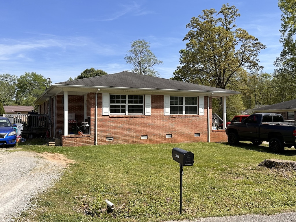 bungalow-style home with a front lawn