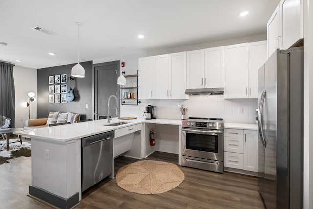 kitchen featuring white cabinetry, dark hardwood / wood-style floors, backsplash, stainless steel appliances, and sink