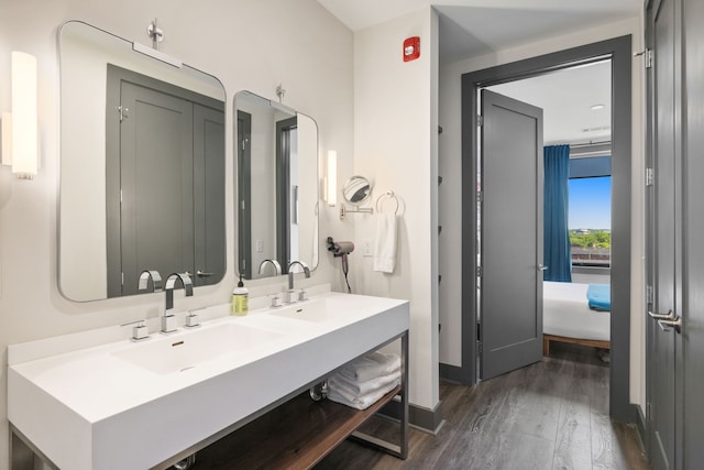 bathroom featuring dual sinks, hardwood / wood-style floors, and large vanity