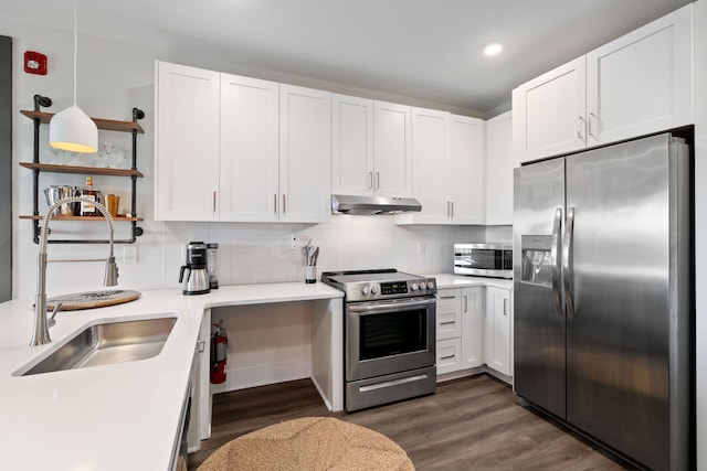 kitchen with dark hardwood / wood-style flooring, white cabinetry, backsplash, appliances with stainless steel finishes, and sink