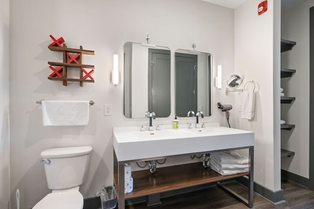 bathroom featuring hardwood / wood-style flooring and toilet