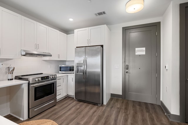 kitchen with dark hardwood / wood-style flooring, appliances with stainless steel finishes, tasteful backsplash, and white cabinetry