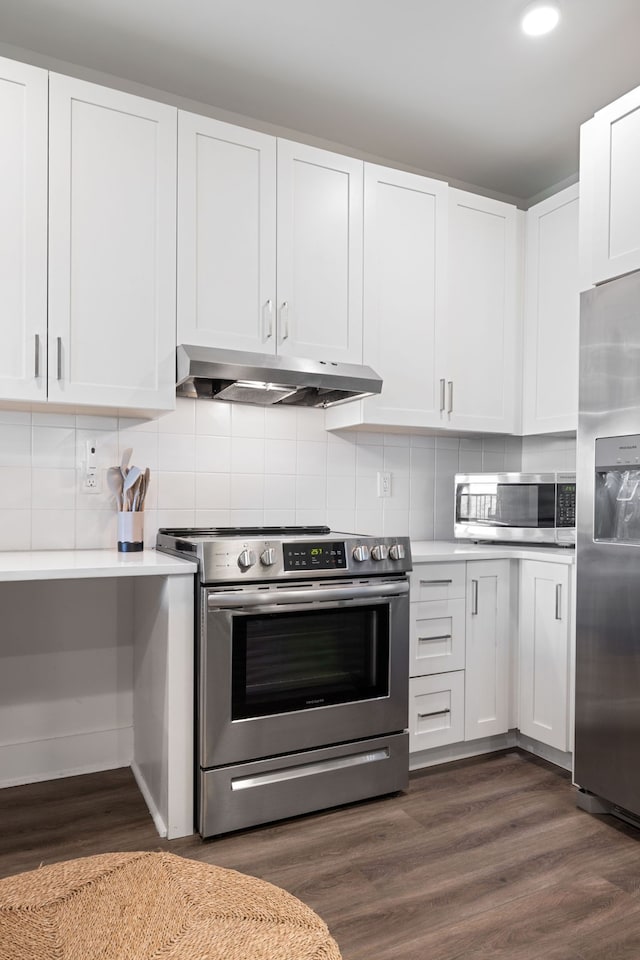 kitchen with backsplash, stainless steel appliances, and dark wood-type flooring