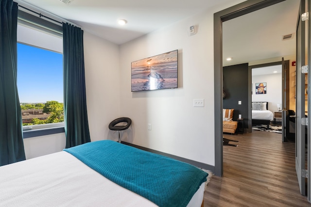 bedroom featuring dark wood-type flooring