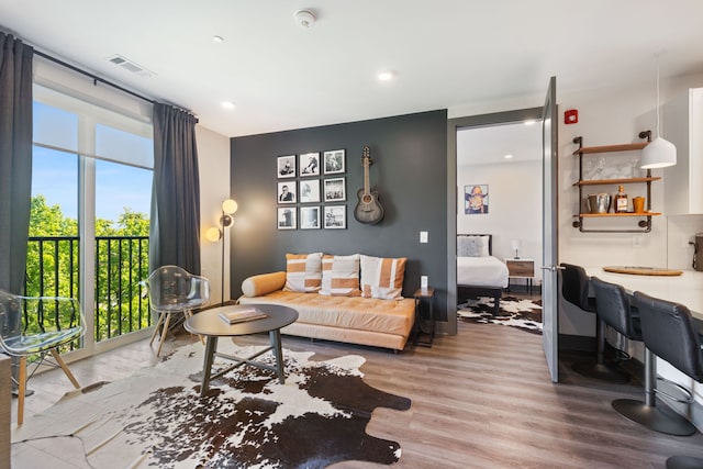 living room featuring hardwood / wood-style flooring, plenty of natural light, and expansive windows