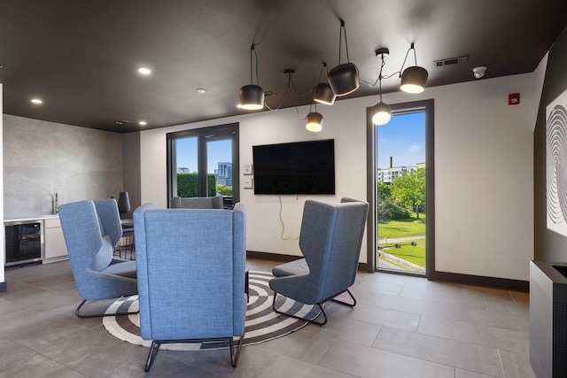 tiled home theater featuring wine cooler