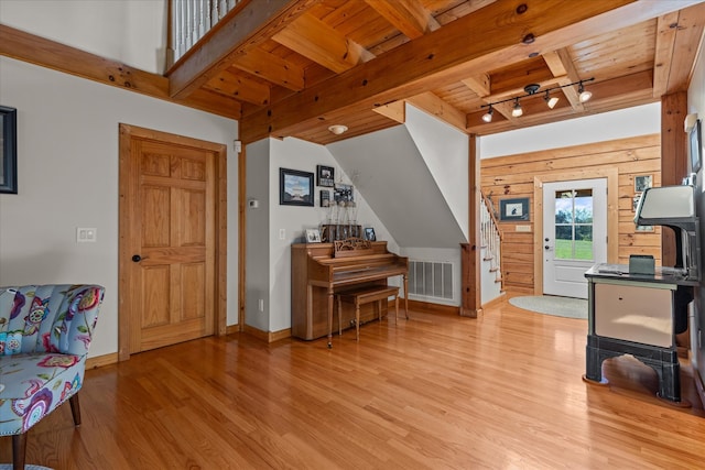 entrance foyer with wood ceiling, light hardwood / wood-style flooring, beam ceiling, and track lighting